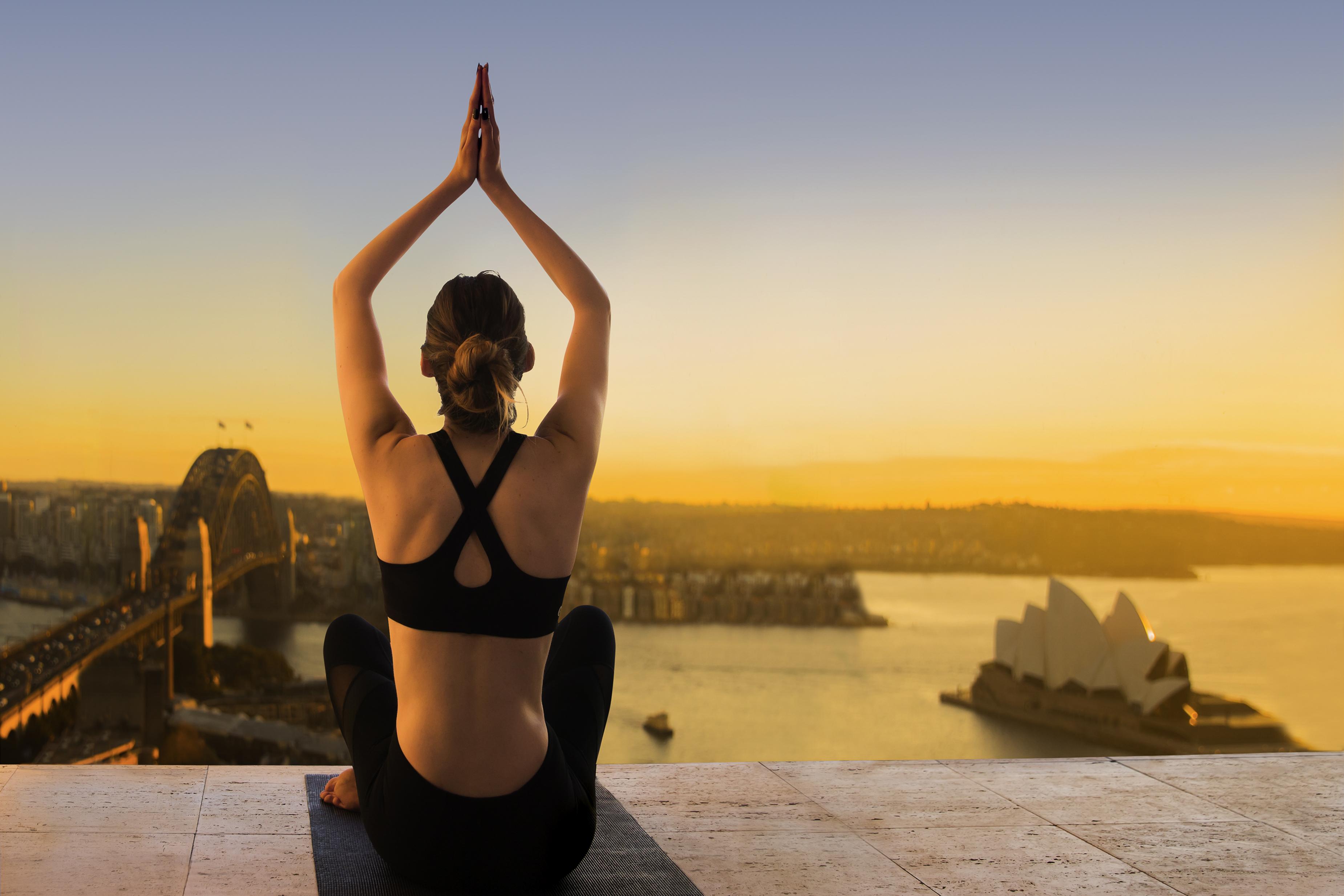 The Sebel Quay West Suites Сидней Экстерьер фото A woman practicing yoga at the Sydney Opera House
